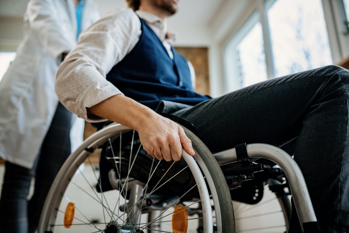 Man in wheelchair with physical disability post accident